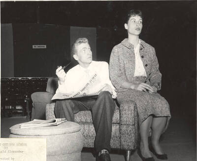 Clifford Cook smokes a pipe and Jacquelyn Bushong sits on the arm of the chair during Idaho drama's production of "Time Out for Ginger." Summer Theatre in the Field House and directed by Howard Dorgan.