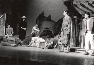 Don Harris, Sam Collet, David Patton, Delbert Bowman, Tom Tureck, Ken Bartlett, Bill Line, Ed Vandevort, Euclid Lee participate in a group scene during a  drama production of 'Teahouse of the August Moon'. The actors are costumed as Japanese villagers and American soldiers. Directed by Jean Collette in the University Auditorium.