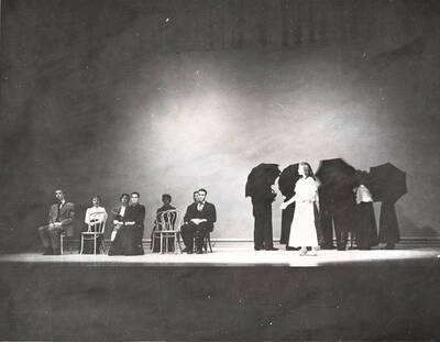 Todd Oleson, Phyllis Erickson, Georgette Amos, Joan Fisher, Phyllis Seeley, Tom Baldwin, Willard Wilson, Antoinette Botsford performing a group scene together during a drama production of 'Our Town'. Directed by Ed Chavez.