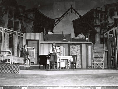 Mary Lou LeFors, Tom Wright, Ed. Hargis and Tom Sawyer perform a group scene together during a drama production 'Death of a Salesman'. ASUI production in the University Auditorium and directed by Jean Collette.