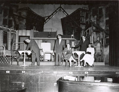 Tom Wright, Tom Sawyer, Dollie Fox, Ed Hargis and Nancy Leek perform a group scene together during a drama production 'Death of a Salesman'. ASUI production in the University Auditorium and directed by Jean Collette.