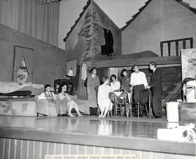 Cast members perform a group scene together during a drama production of 'Diary of Anne Frank'. ASUI production directed by Jean Collette. Cast includes Earl Pederson, Donna Morgan, Vicki Seibert, William Johnston, Gary Whitmore, Sally Willbanks, Diane Fawson, Angie Arrien, Lorenzo Nelson, and Sam Collet.