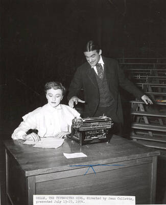 Cast members performing a drama production of 'The Typewriter Girl'. Summer Theatre in the Field House. Caption reads 'BELLE, THE TYPEWRITER GIRL, directed by Jean Collette, presented July 13/15, 1954.'