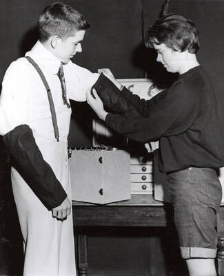 Two individuals facing each other in a room. Summer Theatre in the Field House directed by Donald Hill.