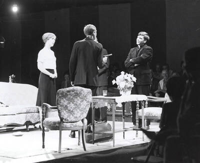 Summer Theatre in the Field House directed by Edmund Chavez. A group of people standing in a circle with one man holding a gun.