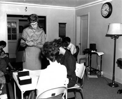 Two women assist another woman with registering for sorority rush in Forney Hall.