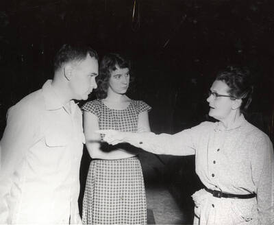 John Tobyn, Joyce Brusati and Agnes Risetter. A woman pointing at a man and the man and another woman at his side looking at the woman pointing. Summer Theatre in the Field House directed by Cecil Matson.