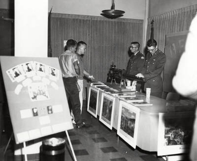 Students look at the Army display in the Lobby and Information Center during the open house after completion of the third addition to the Student Union Building.