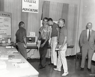 Students look at the College of Agriculture display in the Lobby and Information Center during the open house after completion of the third addition to the Student Union Building.