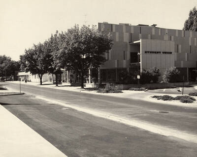 Photograph of the Student Union Building from across the street with trees in the foreground.