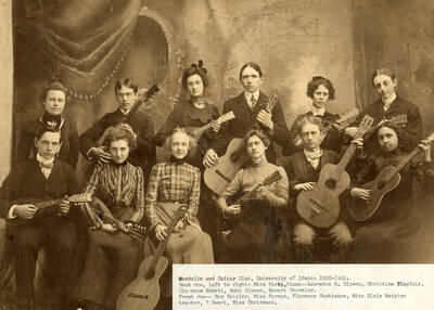 Group photo of the Mandolin and Guitar club. Back: Miss Parks, Lawrence H. Gipson, Christine Playfair, Clarence Edgett, Ruth Gipson, Robert Ghormley; front: Roy Zeigler, Miss Forney, Florence Skattaboe, Elsie Watkins (teacher), Sweet, Miss Chrissman