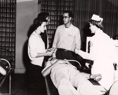 A student gives blood during the Red Cross Blood Drive.