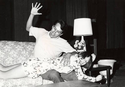 A man acts like he's spanking a woman during the drama production of "Fun & Games."