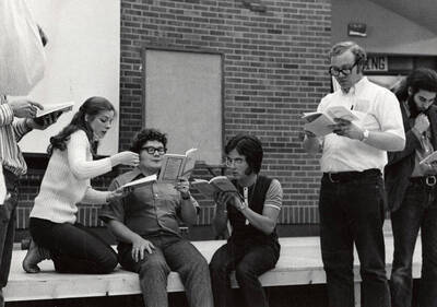 Men and women read through their lines during the drama production "You're a Good Man, Charlie Brown." Summer Theatre directed by Edmund Chavez in the Kiva.