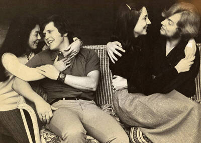 Men and women sit in embraces during the opera production of "La Rondine."