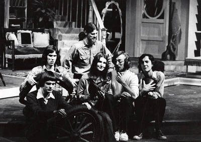 Men and women sit together backstage holding various car parts during the drama production of "Jabberwock." Directed by Ed Chavez. One of the first two shows staged in the Performing Arts Center (Hartung Theater).