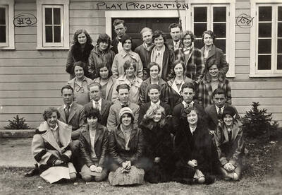 A group of men and women sit together during an elementary play production. Members: Zelda Newcomb, Alice Nash, Doris Brower, Marie Clark, Donald Corless, Alberta Edwards, Evelyn Emahiser, Clayne Robison, Joe Pearson, Vera Forbis, Merle Frizzelle, Frances Gallet, Stanton Hale, Charles Herdon, Caryl Thompson, Gordon Sternke, Dorothy Sage, Cora Jensen, Esther Johnston, Lois Kennedy, Francis Larson, Constance Woods, Melvin Stewart, Helen Wann, Eleanor Williams, Milton Lockwood, Rose Louis, Bertha Moore, Mary Murphy, Roland Sturman. They are outside of the U-Hut.