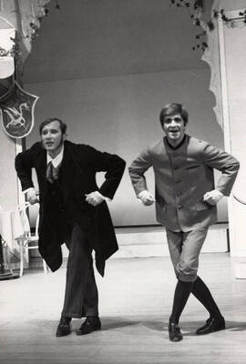 Two men dance onstage during "The Bartered Bride."  Presented by Music and Drama department, directed by Forrest Sears. Music director Charlie Walton. Staged in the University Auditorium.