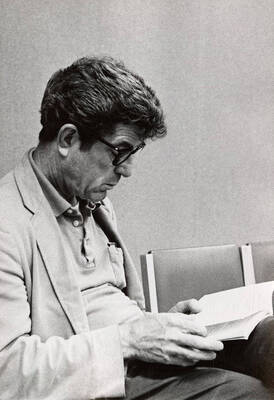 A man sits and reads through his lines during a Summer Theatre rehearsal in the Kiva.