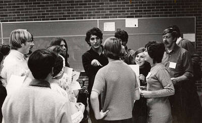 A group of people huddled up, talking during a drama production.