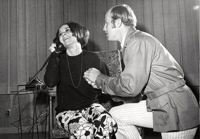 Drama and opera workshop during the University of Idaho production of "The Telephone." A woman can be seen walking on the phone, while a man holds her hand.