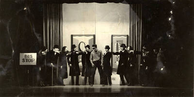 Scene during the University of Idaho drama production of "Hairy Ape." Cast members can be seen dressed in black and standing on stage. Directed by Fred Blanchard, set by Theodore Prichard