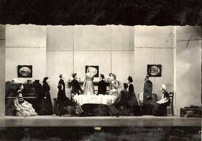 Scene from the University of Idaho drama production of "Trelawny of the Wells." Directed by Fred Blanchard, set by Theodore Prichard. Rose Trelawny is saying goodbye. Members of the cast include Alberta Bergh Utt as Rose Trelawny, Robert Herrick as Tom Wrench, Marion Dresser as Imogen, Clarence Anderson as Colpoys, Jean Ricker as Avonia Bunn and Raphael Gibbs as Sir Gower.