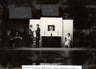 Scene from the University of Idaho drama production of "The Living Corpse." Directed by Fred Blanchard, Technical Director Theodore Prichard. In this scene, Victor promises Lisa that he will bring Freya her husband back. Cast members include Fred C. Blanchard as Fedya, Ethlyn O'Neal as Lisa, Clayne Robison as Victor, Alberta Bergh Utt as Masha, Raphael Gibbs as Prince Sergius, Erma Lewis as Anna Pavlovna, Casady Taylor as Petrovitch, Earl Bopp as Artimiev, and Joe Paquet as Petushkov.