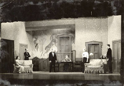Scene from the University of Idaho drama production of "Hawk Island." Directed by Fred Blanchard, Technical Director Theodore Prichard in the University Auditorium. Members of the cast include Lloyd Ruitel as Paul Cooper, Robert Herrick as Anthony Bryce, Margaret Moulton as Sally Rogers and Alberta Bergh Utt as Madeline Austin.