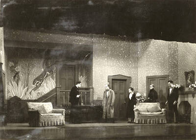 Scene from the University of Idaho drama production of "Hawk Island." Directed by Fred Blanchard, Technical Director Theodore Prichard in the University Auditorium. Members of the cast include Lloyd Ruitel as Paul Cooper, Robert Herrick as Anthony Bryce, Margaret Moulton as Sally Rogers and Alberta Bergh Utt as Madeline Austin.