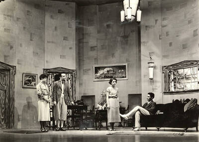 Group scene from the University of Idaho drama production of "A Paragraph for Lunch." Members of the cast include Grace Eldridge, John Thomas, Raphael Gibbs, Harry Robb, Margaret Moulton, Howard Altnow, Betty Brown, Lucile Moore, Elinor Jacobs, John Milner, Marthalene Tanner, and Casady Taylor.