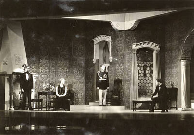 Scene from the University of Idaho drama production of "Death Takes a Holiday." ASUI production directed by Fred Blanchard. Members of the cast include Lionel Campbell as Prince Sirki, Bertha Moore as Grazia, Clayne Robison as Duke Lambert, Winfred Janssen as Eric Fenton, Howard Altnow as Corrado, Raphael Gibbs as Baron Cesarea, and Casady Taylor as Major Whitred.