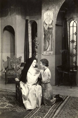 Group scene from the University of Idaho drama production of "The Cradle Song." Directed and designed by Edmund Chavez. In this scene, Sister Joanna of the Cross and Teresa can be seen holding each other's hands. Members of the cast include Bertha Moore as Sister Joanna of the Cross, Margaret Moulton as Teresa, Kathryn Hart Conger, Grace Eldridge, Lucille Moore, Betty Brown, Dorothy Menzies, Naomi Randall, Elinor Jacobs, Alberta Bergh, Elizabeth Loomis, and Lillian Sorenson.