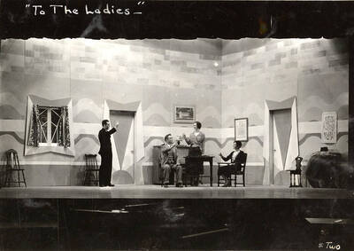 Scene from the University of Idaho drama production of "To The Ladies." Directed by Fred Blanchard. Members of the cast include John Thomas as Leonard Beebe, Catherine Brandt as Elsie Beebe, Elinor Jacobs as Mrs. Kincaid, Harry Robb as John Kincaid, Howard Altnow, John Milner, Casady Taylor, Rollin Hunter, Franklyn Bovey, Winfred Janssen, Walter Pratt, and Edwin Ostroot.