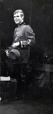 Scene from the University of Idaho drama production of "Little Mary Sunshine." Directed by Edmund Chavez for Summer Theatre in the Field House. The actor can be seen dressed in costume and holding a hat.