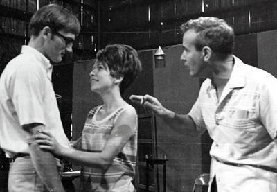 Rehearsal shot of the Summer Theatre production of "Sound of Music." This production was directed by Edmund Chavez, music director Charlie Walton in the Field House. Two actors can be seen looking at each other, while Chavez looks on.