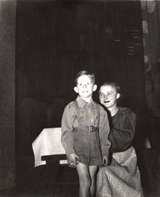 The ASUI production of "Family Portrait." Marie Hargis as Mary and unidentified child. Directed by Jean Collette in the University Auditorium.