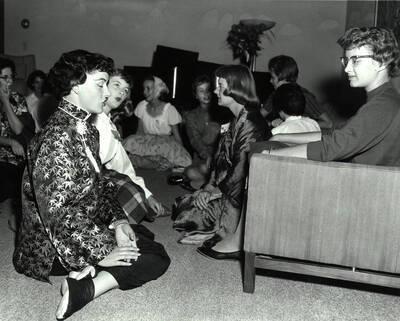 Current members of Gamma Phi Beta sit and talk with interested girls in Gamma Phi Beta's living area during rush week.