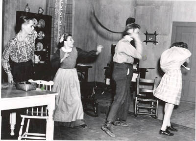 The ASUI production of "Papa Is All." Individuals identified from left to right: Edward Dalva as Jake, Grace Lillard as Mama, William Davidson as Papa, and Marion Wilson as Emma. Directed and designed by Jean Collette in the University Auditorium.