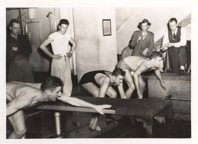 Idaho and Washington State College mermen pictured just before the start of a dash event.