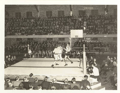 Idaho's Alex Passic lands a right-hook on San Jose State's P. Bolich at a full-house Memorial Gymnasium.