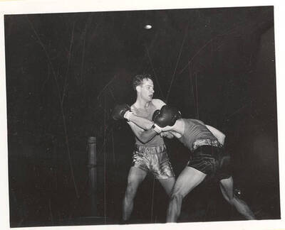 Idaho's Chase Anderson and Oregon State's Jack Wells lock each other up in a clinch-hold for a Memorial Gymnasium bout.