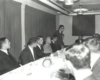 Current and potential Phi Delta Theta members listen to a current member speak during rush week at Phi Delta Theta.