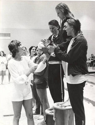The gold, silver and bronze champions line up on their respective podiums to receive their AIAW National Championship medals.