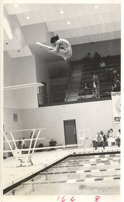 An unsourced women's diver in pike position during the AIAW Nationals in the Swim Center.