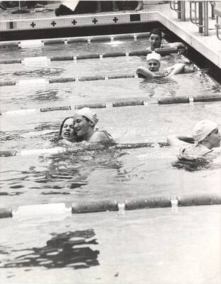 Unnamed victors hug and celebrate in the pool upon winning an event.