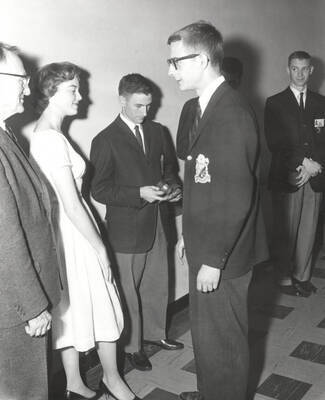 Attendees to the 37th National Convention of the Intercollegiate Knights, a national honorary service organization, network in a hallway.