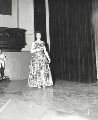 A contestant for queen walks across the Administration Auditorium during the 37th National Convention of the Intercollegiate Knights, a national honorary service organization.