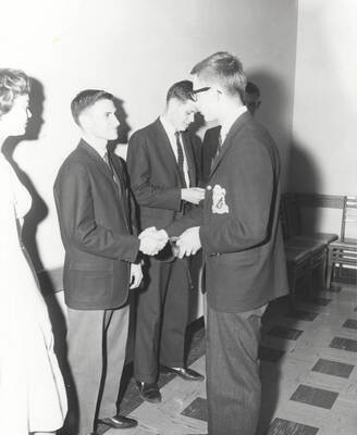 Attendees to the 37th National Convention of the Intercollegiate Knights, a national honorary service organization, network in a hallway.