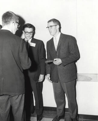 Attendees to the 37th National Convention of the Intercollegiate Knights, a national honorary service organization, network in a hallway.